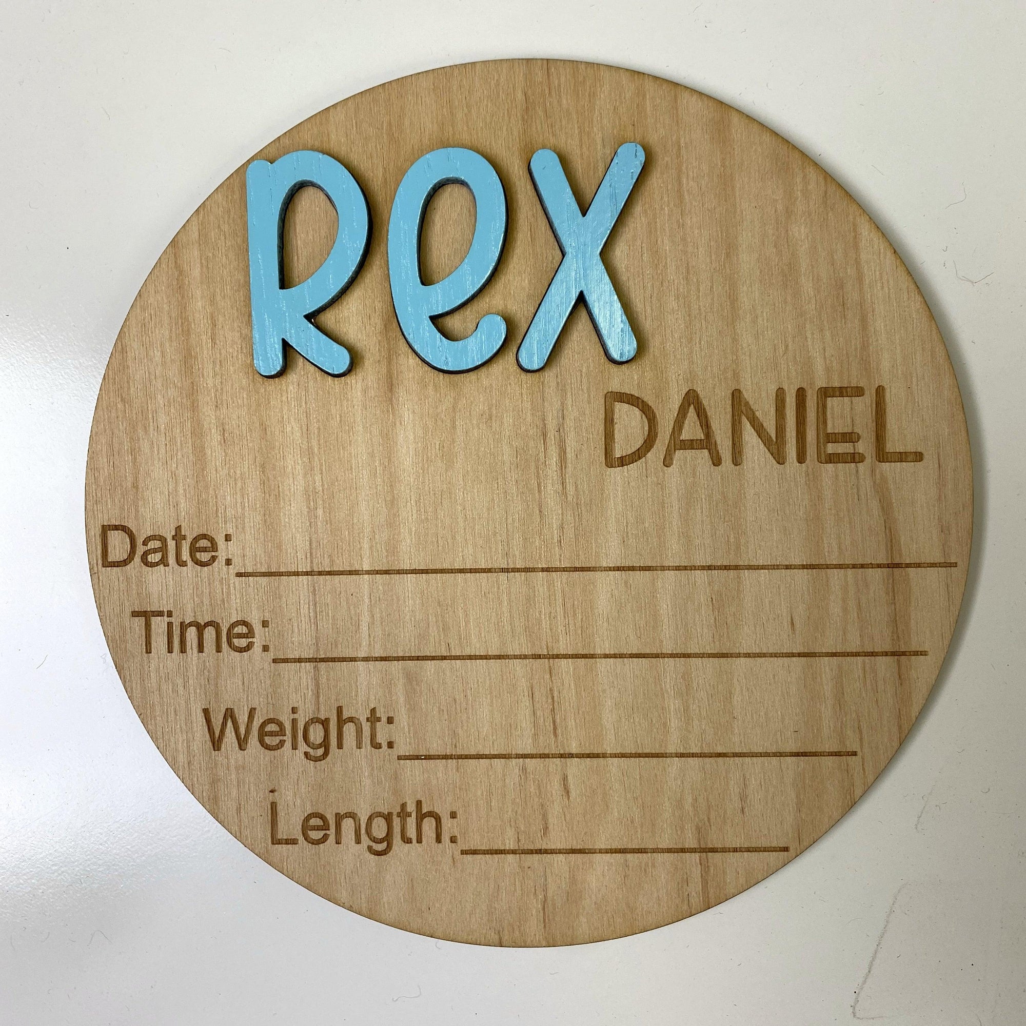 Close up of "Rex" style baby announcement